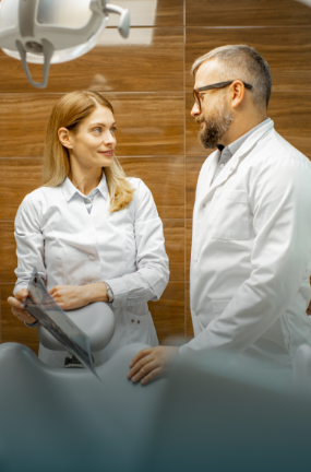 Dentist talking to a woman in the office