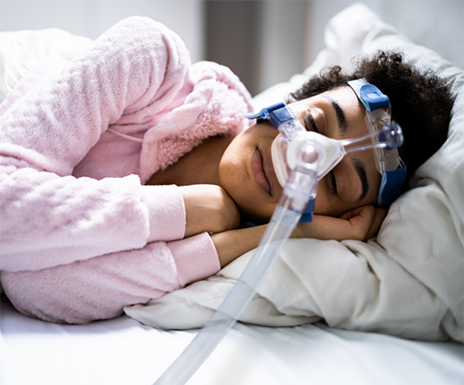 Sleeping woman wearing a CPAP mask