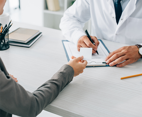 Person handing their payment card to their dentist
