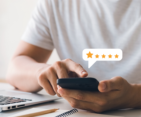 Person leaving a five-star review on their phone