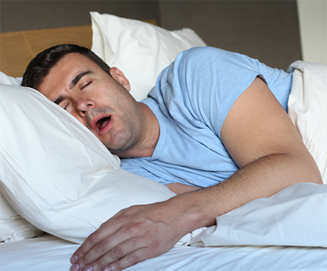 Man sleeping on his side with his mouth open